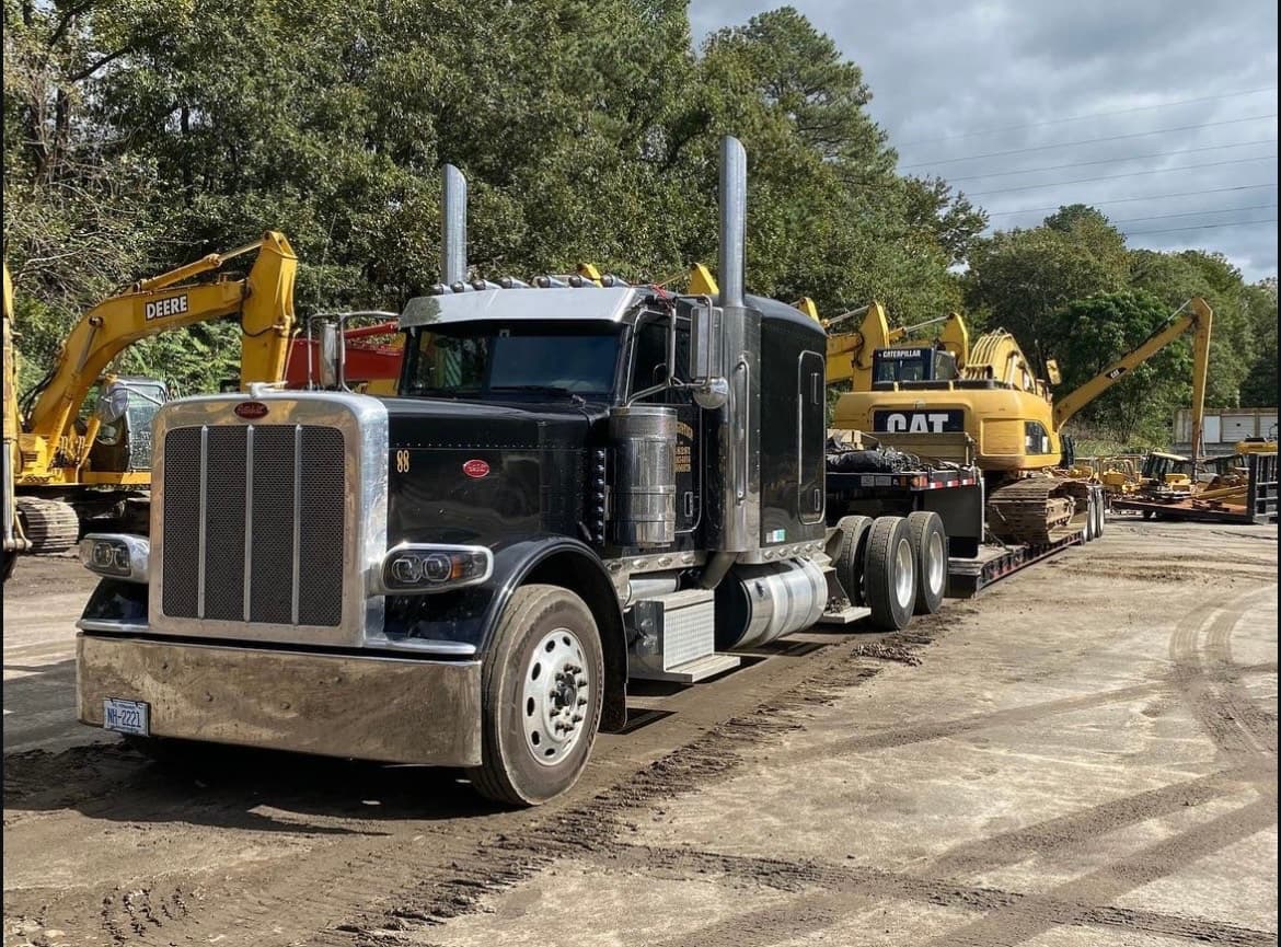 Multi-axle trailer carrying heavy construction equipment